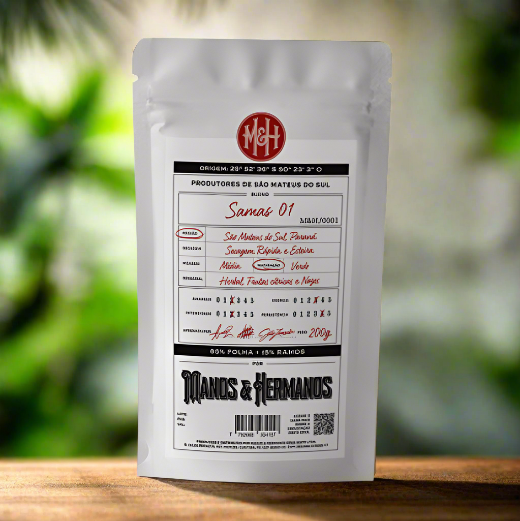 Yerba mate white bag that reads "Manos & Hermanos" with a green and white blurred background.