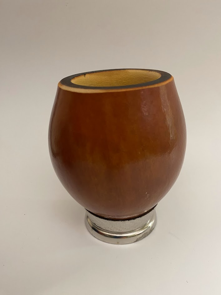 Yerba mate gourd with a metal base at bottom with a white background.