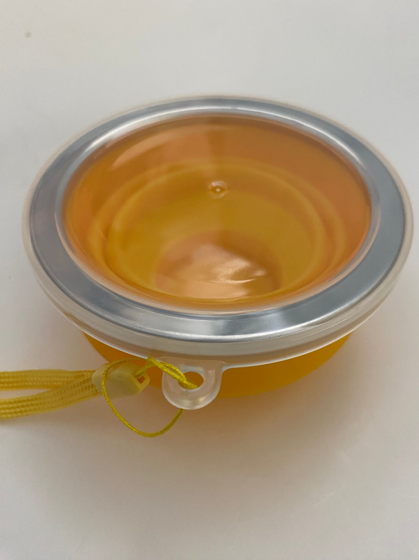 A collapsed mate cup with a metal rim