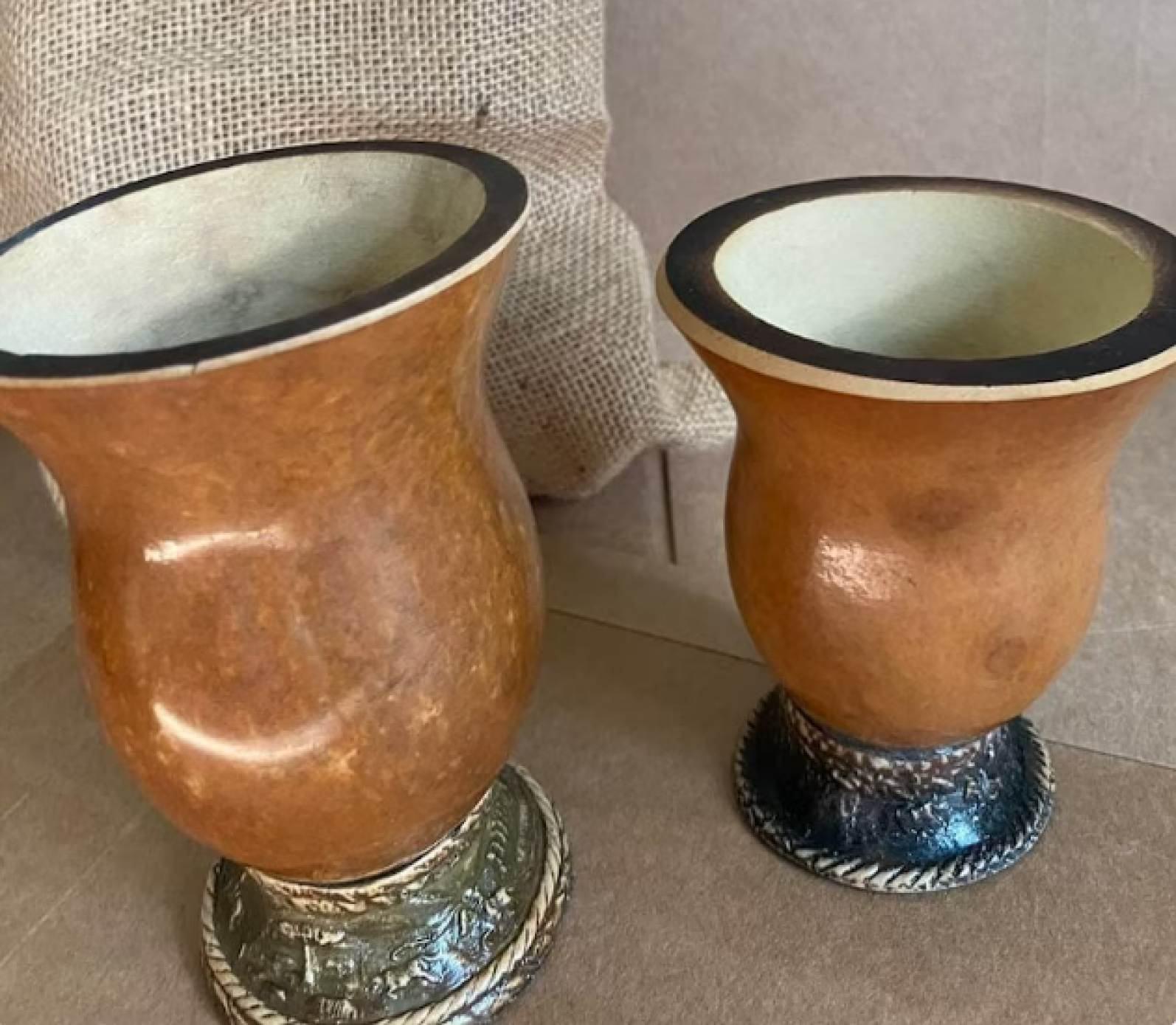 Two Brazilian style yerba mate gourds,  Next to one another 