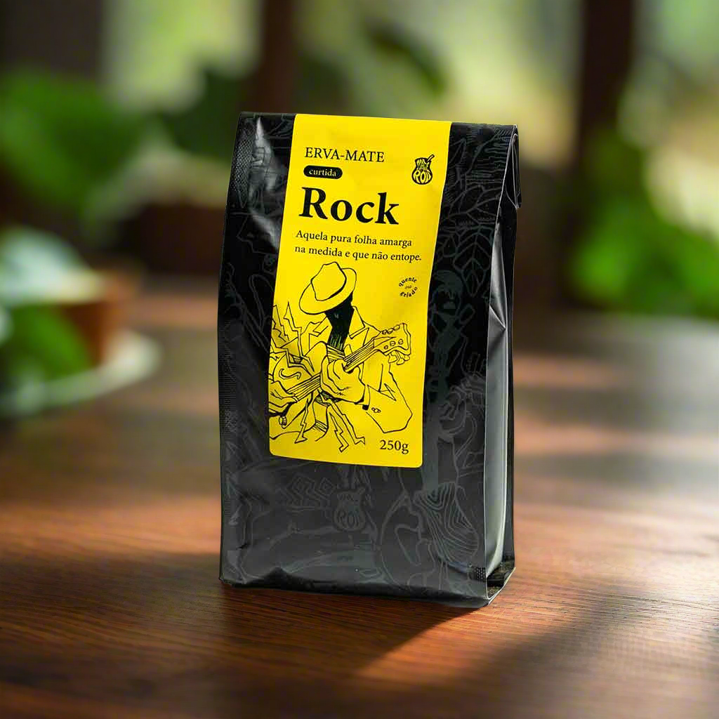 A packaged product labeled 'Matte N Roll Rock' in a black bag with a yellow label, displayed on a wooden surface with plants in the background.