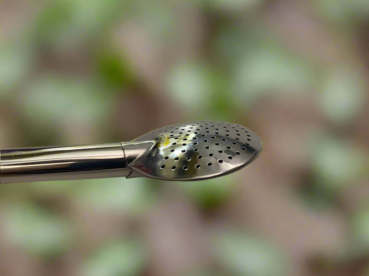 Zoomed in end shot of a bombilla with a blurred forest background