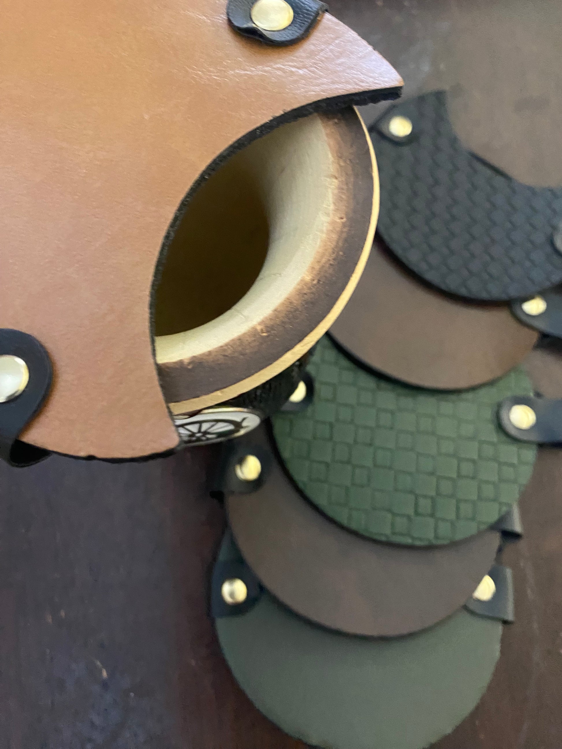 A collection of mate covers in various colors placed on a surface, with one mate head resting on top of another showing the elastic band mechanism.