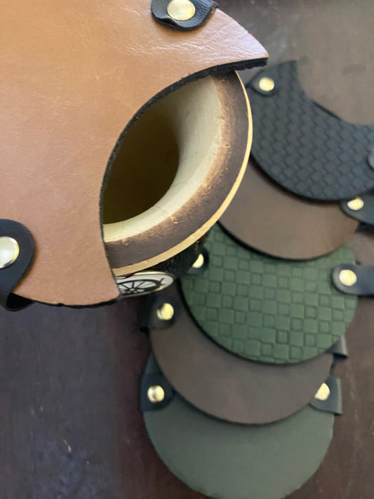 A collection of mate covers in various colors placed on a surface, with one mate head resting on top of another showing the elastic band mechanism.