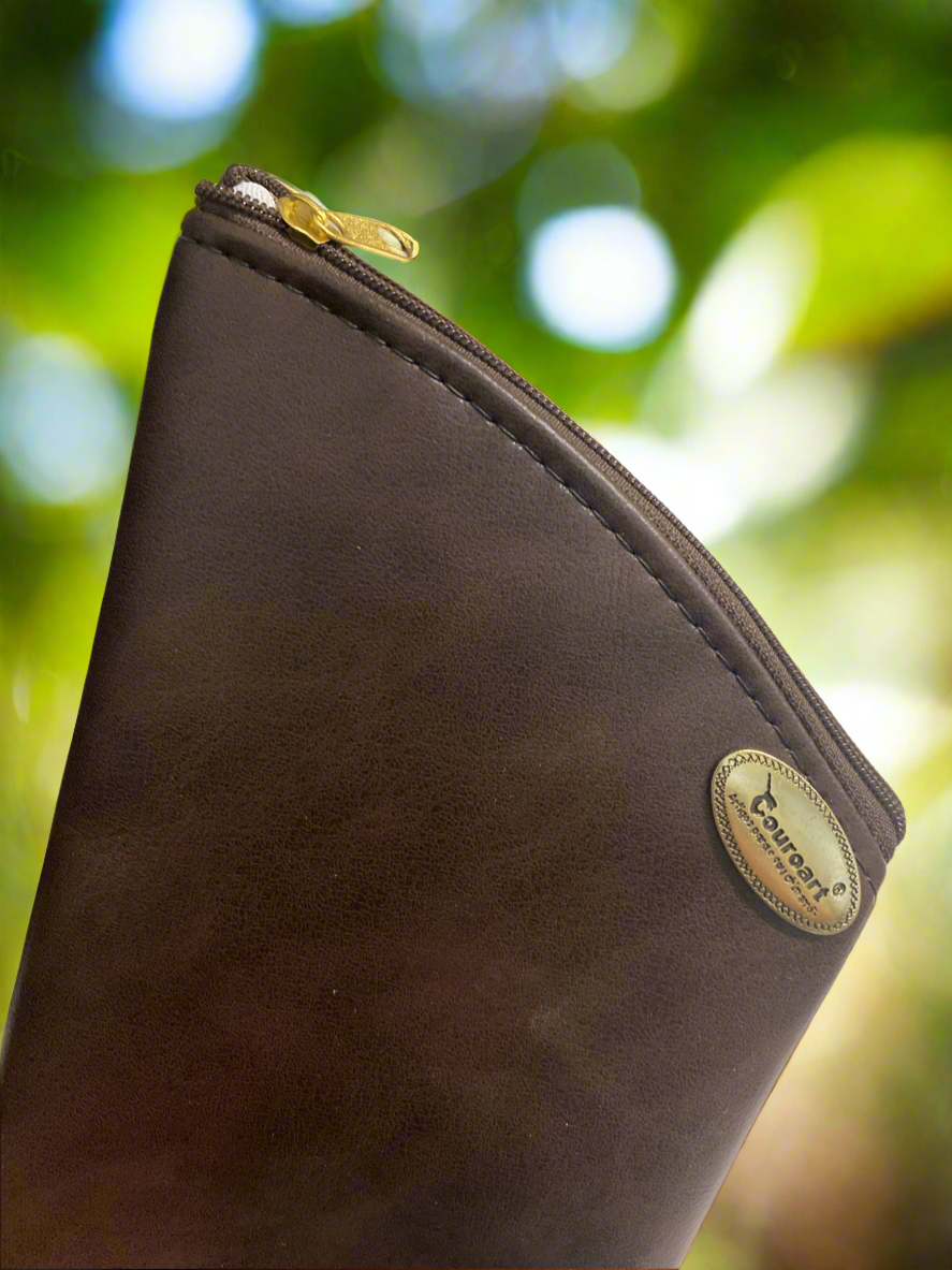 One leather brown leather yerba pouch displayed  with a green plant in the background.