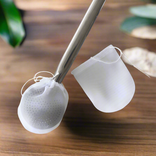 A white bombilla filter with a knot tied at the top, hanging from a metal straw.