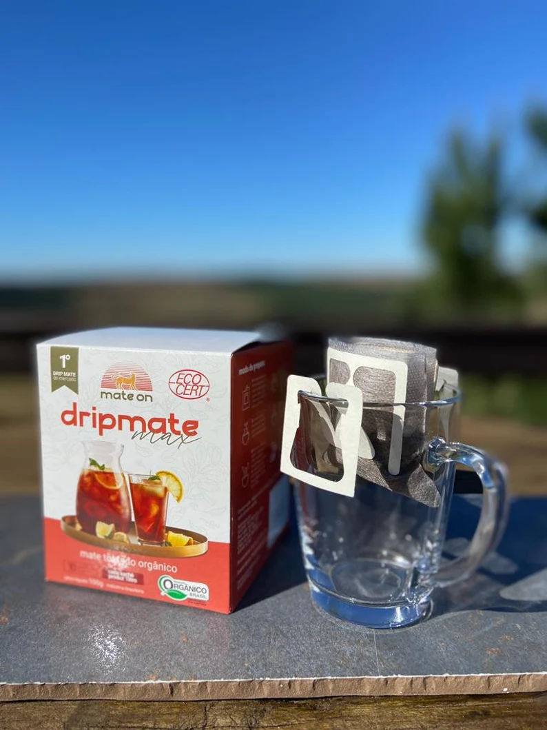 Box that reads dripmate next to a glass mug holding a teabag. 